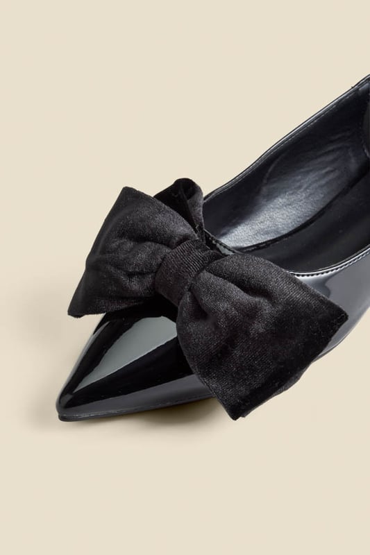 Who needs heels?Luxe patent leather for a hi-shine finish Adorned with a plush velvet bow Wear-forever pointed toe silhouette Flat sole so you can dance the night away We're styling them with wide-leg trousers and a sparkly top