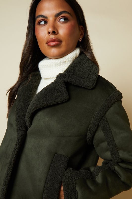 Cropped aviator-style jacket with suede-like finish
        Plush shearling-effect collar and lining for warmth
        Double-breasted front with button fastenings
        Relaxed fit with dropped shoulders for easy layering
        Side pockets for practicality and style
    
    Embrace the cool-weather season with this chic suede cropped aviator jacket from Dorothy Perkins. Perfect for the fashion-forward woman who values both style and comfort, this versatile piece is ideal for casual outings and family gatherings. The jacket's cropped silhouette adds a modern twist to the classic aviator style, while the plush shearling-effect details provide cosy warmth. Style it as seen on the model with a crisp white turtleneck, wide-leg trousers, and chunky boots for a trendy brunch look. Alternatively, throw it over a floral midi dress and ankle boots for a charming baby shower ensemble. The relaxed fit allows for easy layering, making it a go-to choice for unpredictable British weather. Whether you're meeting friends for coffee or running weekend errands, this jacket will keep you looking effortlessly stylish and feeling comfortable all day long.