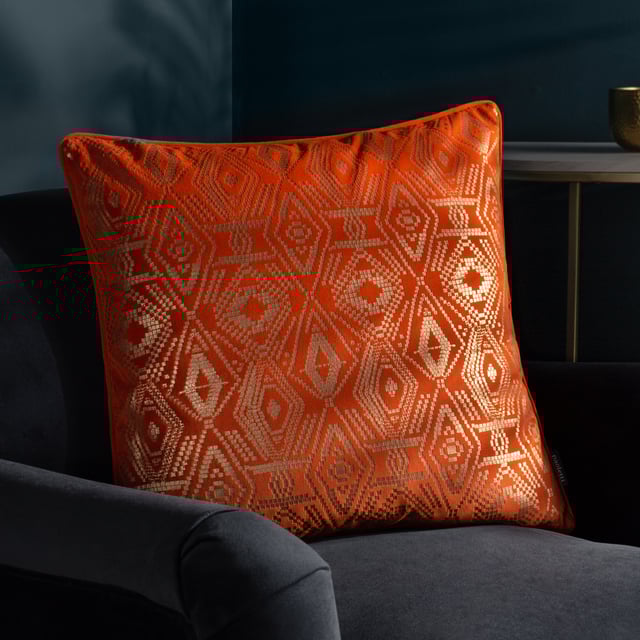 A myriad of golden diamonds adorns this mesmeric velvet cushion. The glistening metallic foil printed pattern shines in the light and stands out against the bold jewel-toned backgrounds. The cushion is surrounded by a matching piped trim, hidden zip closure, and a plain, soft velvet reverse. A fantastic addition to a home which loves to show off and stand out.