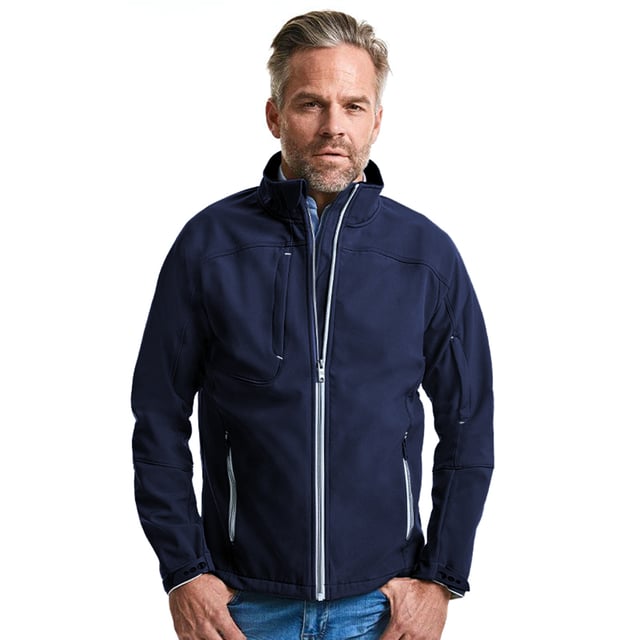 Softshell jacket with a timeless design. Highly water and wind resistant. Contemporary shaped fit. Contrasting zips and accents for a refined look. Covered zipped pockets: one at chest and one at sleeve. Protecting chin guard. Stand-up collar and inner storm flap to ward off wind and draught. Adjustable sleeve hems with injected cuff tabs and loop touch fastening. Materials: 94% Polyester, 6% Elastane.