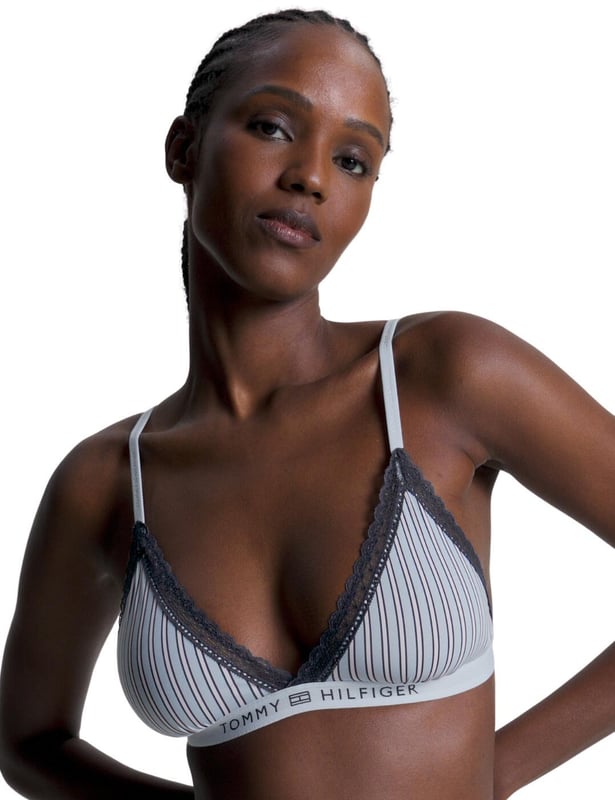 The chic Tommy Hilfiger triangle bra is the perfect addition to your lingerie collection this season. Unpadded and unlined, this dainty bra is designed with your comfort in mind. Combining an understated look with subtle hints of femininity, the stretch recycled nylon material will adapt to your body while the hook and eye fastening keeps it securely in place. The signature Tommy Hilfiger tonal logo elasticated underband delivers a modern look which perfectly compliments the lace trims for a refined twist. The adjustable shoulder straps and hook and eye closure are perfect for achieving the right fit, and the wireless cups ensure an unrestricted feel, providing you with an all-day level of comfort. Crafted with timeless style, this Tommy Hilfiger triangle bra is a must-have.

Wireless
Non-padded
Adjustable shoulder straps
Hook and eye closure on back
Lace trim for a feminine look Plunging neckline
Country of origin: China&nbsp;
Composition: 79% Recycled Nylon | 21% Elastane
Listed in UK sizes.