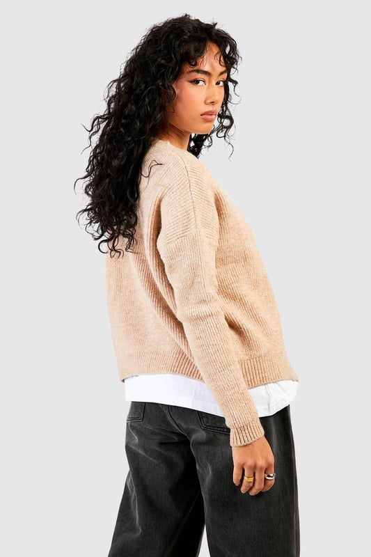 Soft knit texture for ultimate comfort
        Slouchy, relaxed fit for effortless style
        Eye-catching rhinestone buttons add a touch of glamour
        Versatile open-front design for easy layering
        Ribbed cuffs and hem for a polished finish
    
    Embrace laid-back luxury with this slouchy cardigan, perfect for the fashion-forward woman who values both style and comfort. The soft knit fabric drapes beautifully, creating a relaxed silhouette that's ideal for casual outings or cosy nights in. The standout feature is undoubtedly the sparkling rhinestone buttons, which add a subtle touch of glamour to this otherwise understated piece. Style it over a simple white tee and wide-leg trousers for a chic daytime look, or throw it on over a slip dress for an evening ensemble with a twist. For a trendy finish, pair with a beanie and chunky trainers as seen on our model. This cardigan is a versatile staple that will quickly become your go-to for family gatherings, coffee dates, or lazy weekends at home.