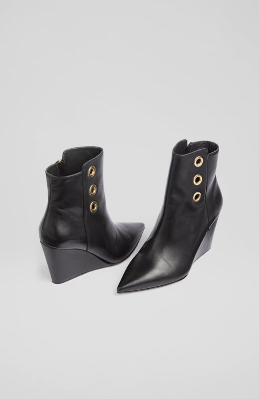 LK Bennett Brie Ankle Boots,Black A stand-out pair of ankle boots in our new collection, the Brie boots offer wear-all-day comfort and contemporary chic in equal measure. Beautifully made in Italy from buttery soft black nappa leather, they have a pointed toe, gold eyelet detail, an inside zip and a leather wedge 80mm heel. Sleek and sexy, slip them on with dresses and skirts as well as smarter, more tailored looks.