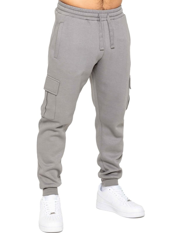 Experience superior comfort and style with Enzo Men's Regular Fit Cargo Joggers! Crafted with a brushed back inner fleece lining, these joggers are designed to keep you cozy all day long. Perfect for casual wear, they feature convenient 2 side slash pockets and 2 cargo pockets, providing ample storage space for your essentials. Stay on-trend with the cuffed leg design, offering a modern silhouette and added comfort.