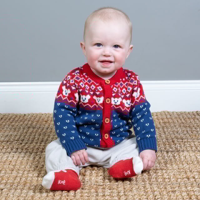 A simply gorgeous knitted layer that offers both comfort and style and is the perfect winter cardigan for your little one. In our midweight knit with a beautiful red and cream Fair Isle design around the yoke, this fab layer with coconut buttons is so snug and versatile it will be worn again and again.