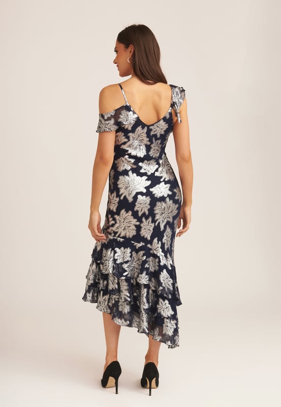 Saluda a este vestido midi con volantes florales imprescindible que es perfecto para cada ocasión. Si tienes una invitación para la boda de tu muñeca favorita, este vestido midi cumple todos los requisitos del código de vestimenta. Con un gran estampado floral y detalle de volante en el escote, ¿cómo podrías decir que no? Combina este vestido midi con tus tacones y tus accesorios favoritos para lograr un look que no pasará desapercibido.