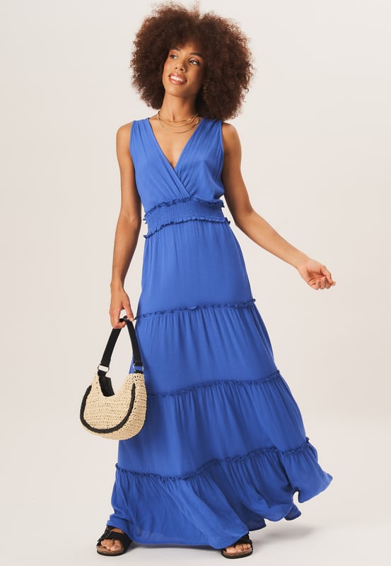 Stay stylish and comfortable in our  Shirred Waist Tiered Midi Dress. This versatile dress features a flattering shirred waist and a tiered design for a fashionable look. Perfect for any occasion, it will effortlessly elevate your wardrobe.