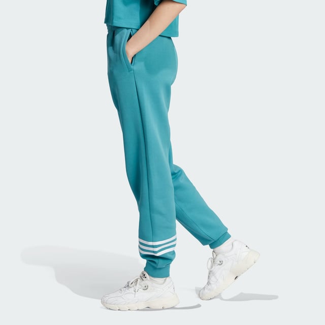 Stay sharp even when the day calls for relaxation. These adidas Adicolor joggers blend a sporty vibe with stylish design to make sure you look good even in your downtime. 3-Stripes around one leg add an unexpected, asymmetrical look to the casual, laid-back piece. Whether you're chilling at home or need to step out of the house, these relaxed-fit pants make sure you always look on point.A minimum of 70% of this product is a blend of recycled and renewable materials.  - This model is 175 cm and wears a size S. Their chest measures 81 cm and the waist 60 cm. - Relaxed fit - Drawcord on elastic waist - 66% cotton, 34% polyester (recycled) - Side zip pockets - Elastic cuffs  Shipped by adidas
