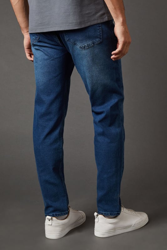 Tapered fit for a modern silhouette
        Classic five-pocket design
        Belt loops for versatile styling
        Subtle whiskering detail for a lived-in look
        Ankle-length cut perfect for showcasing footwear
    
    These Burton tapered fit jeans offer a perfect blend of comfort and style for the discerning gent. The tapered leg creates a sleek, contemporary profile that's ideal for both casual outings and smart-casual occasions. Pair them with a crisp white shirt and loafers for a pub lunch with mates, or dress them down with a favourite rugby shirt and trainers for a relaxed weekend look. The versatile design makes these jeans a wardrobe staple, easily transitioning from daytime errands to evening gatherings. The subtle whiskering adds character, while the classic five-pocket layout ensures practicality. Whether you're heading to a family barbecue or catching the match at your local, these jeans will keep you looking effortlessly stylish and feeling comfortable throughout the day.