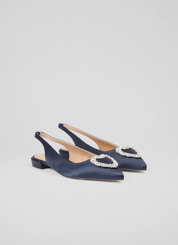 The definition of a 'fancy flat', the Luana slingbacks can elevate almost any look this spring/summer season with their subtle sparkle. Crafted in Spain from sumptuous navy blue satin, they have a pointed toe, a heart-shaped silver crystal brooch designed exclusively for LKB, an elasticated slingback, and a flat heel. Wear them to dress up a pair of jeans, or with dresses when you need a break from heels.