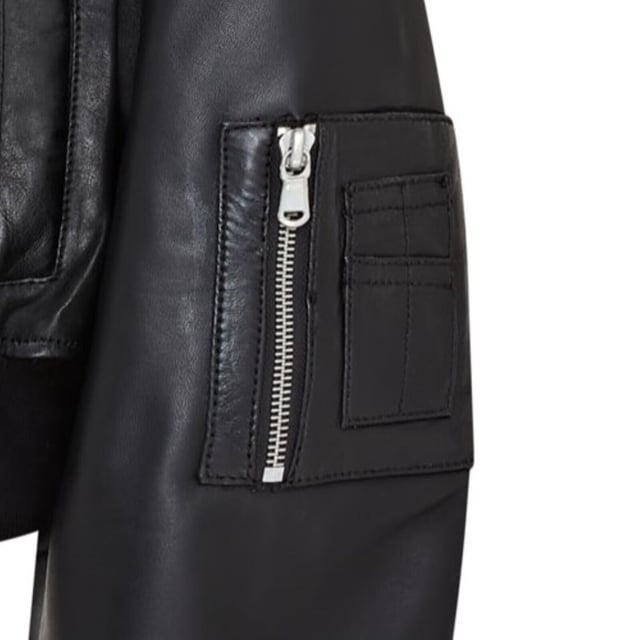 Elevate your style with this effortlessly cool, black cropped leather bomber jacket. Designed for a relaxed, oversized boyfriend look, this piece is crafted from soft sheep nappa leather, featuring expertly aged seams and pockets for a vintage appeal. A robust YKK zipper leads to a classic shirt-style collar, while the rib-knit hem and cuffs ensure a snug fit and warmth. With two waist pockets and a zipped sleeve pocket, plus a luxurious satin lining with a leather-trimmed interior pocket, this jacket blends functionality with edgy sophistication. Soft, aged sheep nappa leather, Oversized fit, Chunky YKK zipper, Rib-knit hem and cuffs, Satin-lined with leather-trimmed interior pocket
