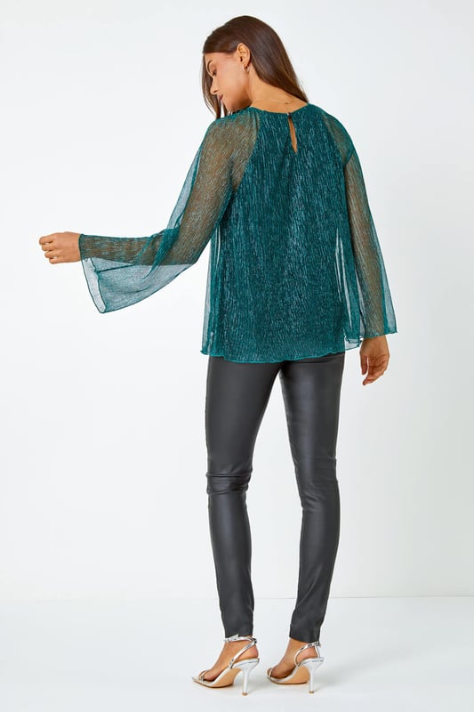 Plisse Overlay Wide Sleeve Top from Roman. Party all night in this plisse top! Cut from a glistening shimmer fabric, this top features a modest round neckline and extravagant wide sleeves to create a playful yet sophisticated style. Designed with a fitted underlay to keep you covered this top features a flirty keyhole cutout that accentuates the button fastening at the back of the neck. Pair with faux leather trousers and strappy heels and you’re sure to be the star guest at all of this season's parties!