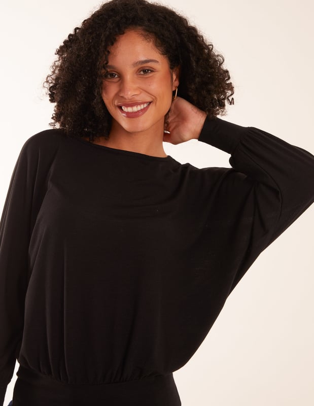 Doesn't matter if you are going to work or a late-night cocktail with friends, you will not go wrong with the batwing top. You can match this top with wide leg jeans and short heel boots.