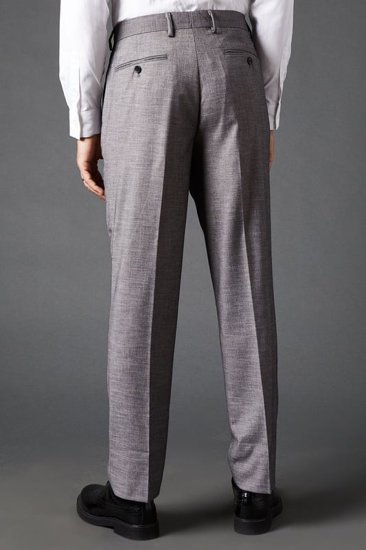 Tailored fit for a refined silhouette
        Sharkskin texture adds subtle sophistication
        Belt loops for versatile styling options
        Side pockets for practicality
        Pressed centre creases for a crisp look
    
    These mid grey sharkskin trousers offer a perfect balance of style and comfort, ideal for the modern gentleman who appreciates classic tailoring. The tailored fit sculpts your silhouette while allowing ease of movement, making them suitable for long days at the office or evening events. Pair them with a crisp white shirt and matching jacket for a complete suit look, or dress them down with a light jumper for smart-casual occasions. The versatile mid-grey hue allows for effortless coordination with various shirt colours and accessories. Whether you're heading to an important business meeting, a wedding, or a sophisticated dinner, these trousers will ensure you look polished and feel confident. Their timeless design makes them a wardrobe staple that will serve you well for years to come.
