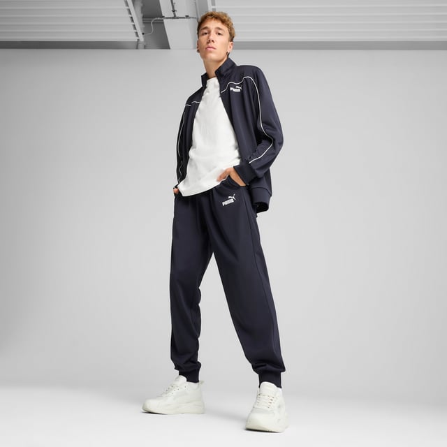 PRODUCT STORY: These everyday essentials feature a high-collar jacket with rib cuffs and waistband, plus pants with an elastic waistband and internal drawcord for customized comfort. PUMA No. 1 Logo rubber prints and piping details complete the look. FEATURES & BENEFITS: Made with at least 90% recycled materials. DETAILS: Regular fit; High-collar; Elastic waistband with internal drawcord; Ribbed cuffs; Closed bottom; PUMA branding details; 100% polyester Recycled - tricot - 220.00 g/m - piece dyed - Mechanical - Brushing, Mechanical - UPFMain Material 3: 100% polyester Recycled - tricot - 220.00 g/m - piece dyed - Mechanical - Brushing, Mechanical - UPF.  Our model is 180 cm tall and is wearing size M UK.