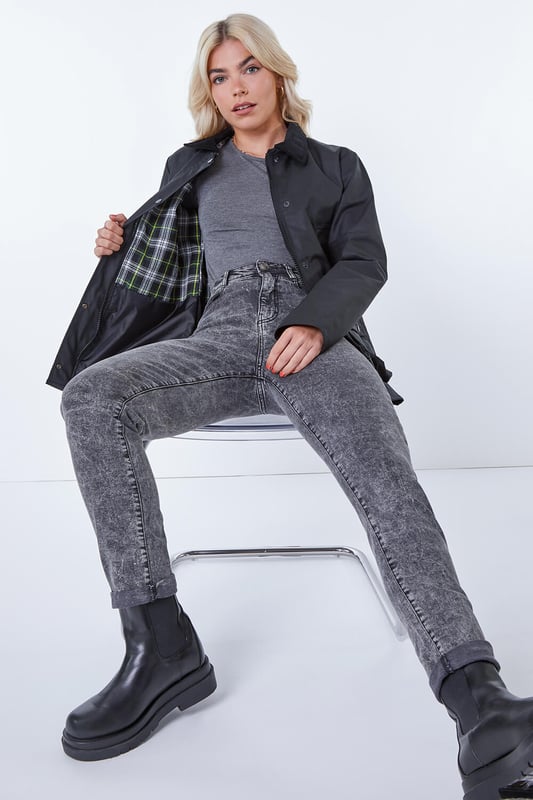 Checked Lined Wax Coat from Roman. Chic and comfortable this short waxed jacket is as fashionable as it is practical. Made from a 100% cotton fabric finished with a protective waxed coating this is sure to keep you dry. Its short length keeps it light and cool. It features a contrast, cord collar and useful pockets with secure popper fastenings. It has a full front zip opening with popper overlay for extra security. It’s finished off with a heritage check inner lining. Pair with knitwear and denim for walks with friends!