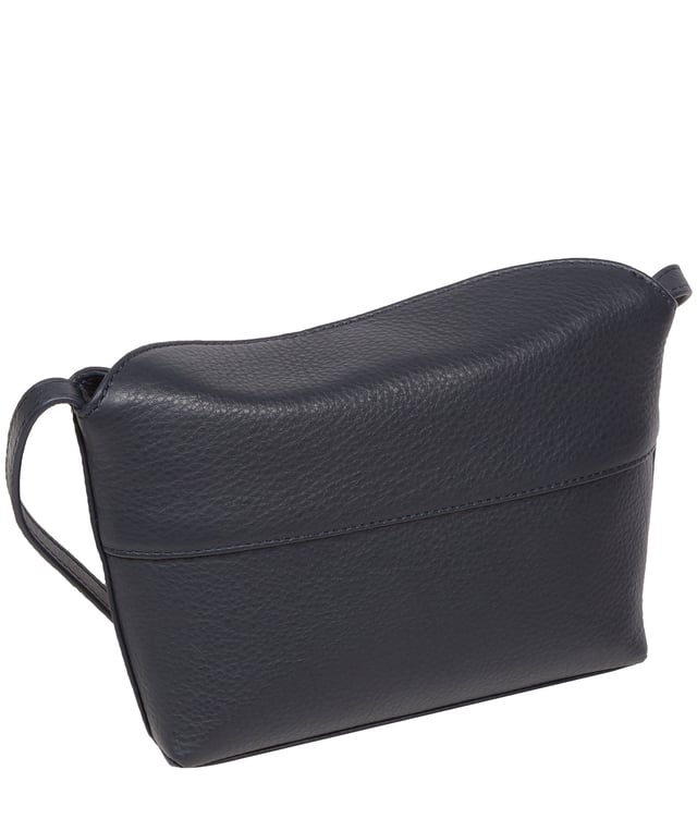 The 'Lolo' cross body bag from the Pure Luxuries Marylebone collection is handcrafted from high-quality, genuine Nappa leather with a natural super-soft touch. The bag is secured by a magnetic closure which opens to reveal a 100% cotton-lined interior and includes two slip pockets. Features gold-coloured metal fittings alongside the adjustable slim leather strap, with a maximum drop length of 65cm. The Pure Luxuries logo is embossed in gold foil for a beautifully simple finishing touch.