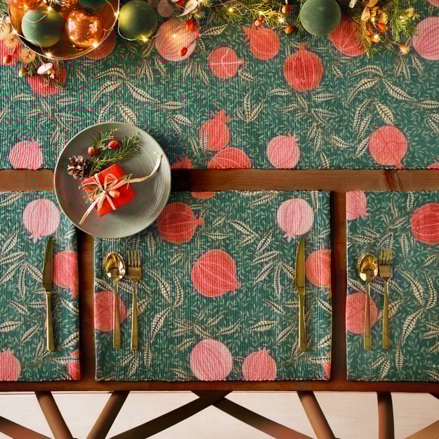 Displayed in all its glory, the Pomegranate set of four placemats is the perfect addition to your home this festive period. Digitally printed for exceptional clarity on a durable woven polyester fabric, the opulent, juicy fruits intertwine with gold leaves, complimenting the warming green background. A refreshing alternative to traditional festive decor, this beautiful set brings richness to the Christmas dining table and will look fantastic all year-round.