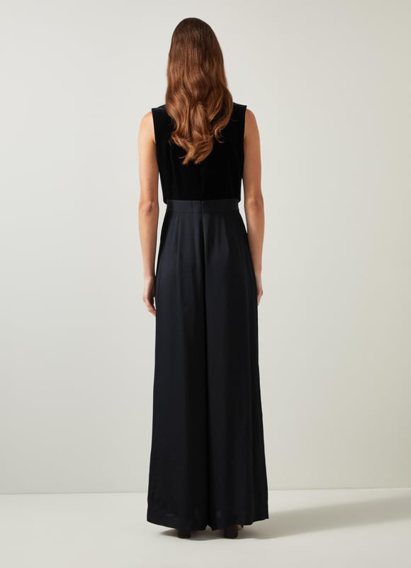Be the center of attention with the Carine waistcoat culotte jumpsuit, ideal for evening events. In sleek black, this cotton blend jumpsuit boasts a v-neck, sleeveless design, mixed media details, and convenient pockets with a back zip. Combine it with statement heels and a clutch for an effortlessly stylish appearance.