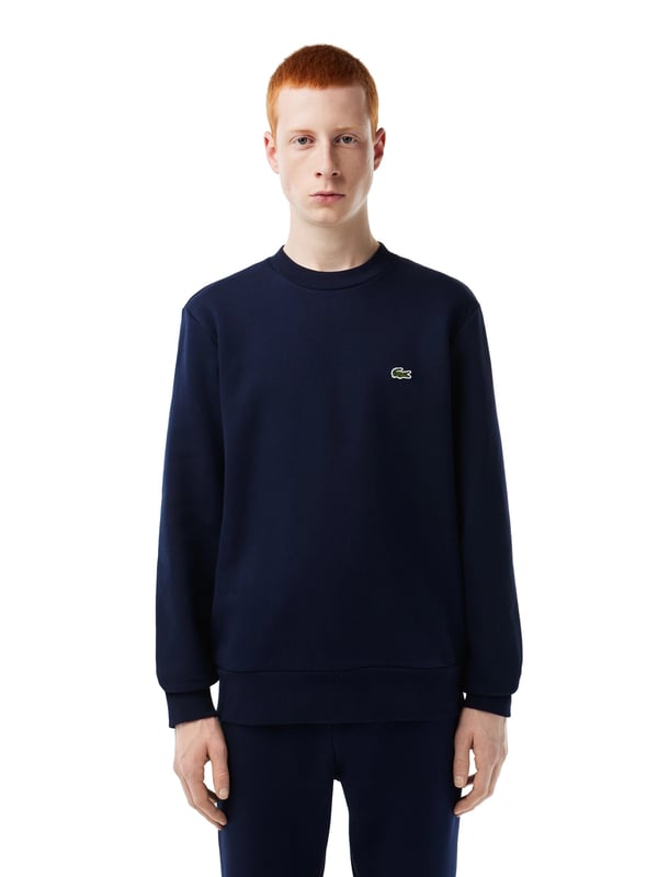 Solid-colored sweater with a round neckline, ribbed cuffs and subtle logo patches in a regular fit.