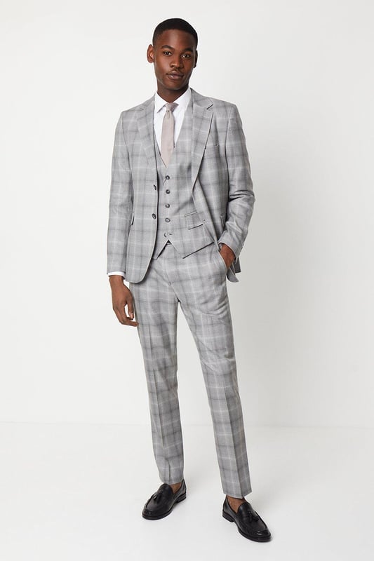 Slim fit tailored trousers with a sleek, tapered silhouette
Crafted from a fine grey check patterned fabric
Flat front styling with slant side pockets
Belt loops to accommodate a smart leather belt
Hem designed to sit neatly on the shoe

Exuding refined sophistication, these slim fit trousers from Burton are the epitome of smart tailoring. Pair them with a crisp shirt and blazer for a polished look at formal occasions or dress them down with a knitted jumper for elevated weekend styling. The slim cut flatters the frame while the grey check pattern adds a touch of classic British flair, making them a versatile choice for the modern gentleman's wardrobe.