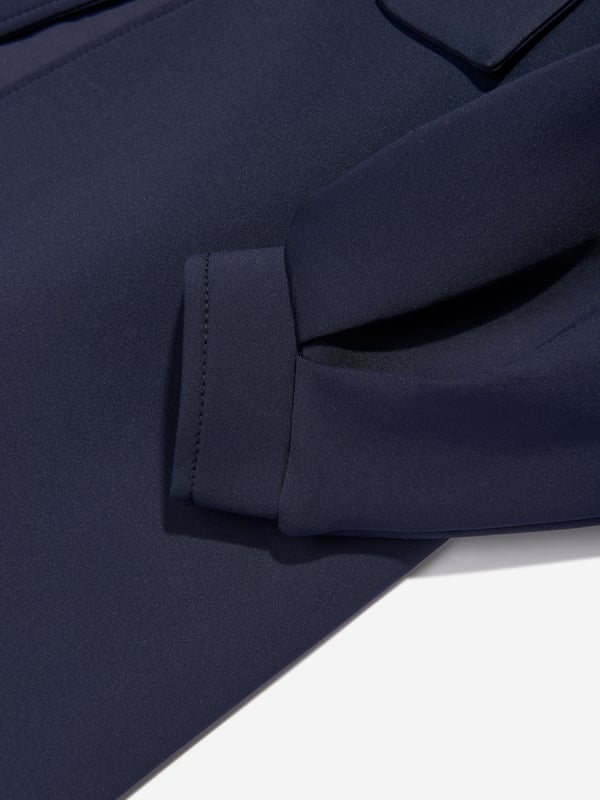 Mama Luma incorporate beautiful eco-friendly materials into their sophisticated handmade constructions. This girls navy long coat is reflective of the Californian label's precision of beauty. It showcases a Peter Pan collar, tie-up bow and balloon sleeves.  Cuffs Cotton Lining