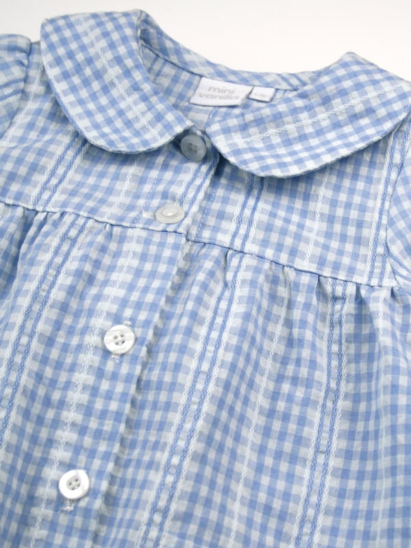 Pretty in blue... We think you're going to love our new seersucker mini check in the most beautiful pastel blue and white. There's so much woven detail in this fabric design.
Spring & Summer weight 100% Cotton with short puffed sleeves
Understated and timeless styling, our classic styling has a peter pan collar, engraved pearl effect buttons, front pockets and feminine gathers. With the trousers having an elastic waist, it makes them easy to get on and off. Our beautiful girls PJ set will keep your little one cool on the hot summer nights!
100% Cotton
Elastic waist
Front pockets
Button through top
Machine washable
Peter Pan collar