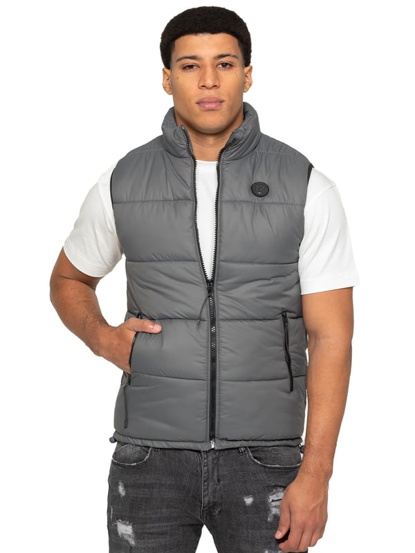 Embodying both fashion and function, the Enzo Mens Puffer Gilet boasts a water-resistant design and a high neck for added warmth. It also offers secure storage with zipped side pockets, and a custom fit with its elasticated hem and adjustable toggle. The full zip-up front and lined interior provide ultimate comfort and practicality. With a EZ branded badge on the chest, this gilet is crafted from durable 100% polyester and is conveniently machine washable.