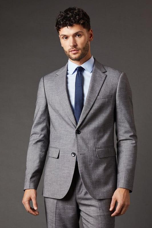 Slim fit design for a modern, tailored silhouette
        Sharkskin texture adds subtle depth and interest
        Notched lapels and two-button closure for classic styling
        Flap pockets and chest welt pocket for practicality and style
        Versatile mid-grey hue suitable for various occasions
    
    This Burton slim fit suit jacket radiates sophistication and versatility, perfect for the modern gentleman who appreciates timeless style with a contemporary edge. The sharkskin texture lends a subtle depth to the fabric, catching the light in a way that adds intrigue to your ensemble. Pair it with the matching trousers for a complete look that's ready for the boardroom, or dress it down with dark denim for smart-casual events. The jacket's slim cut flatters the physique, creating a sharp silhouette that's ideal for everything from important business meetings to after-work drinks with colleagues. Accessorise with a crisp white shirt and a bold tie to make a statement, or opt for a light blue shirt for a softer approach. This versatile piece is a wardrobe essential for the man who moves effortlessly between professional and social settings, always looking impeccably put together.