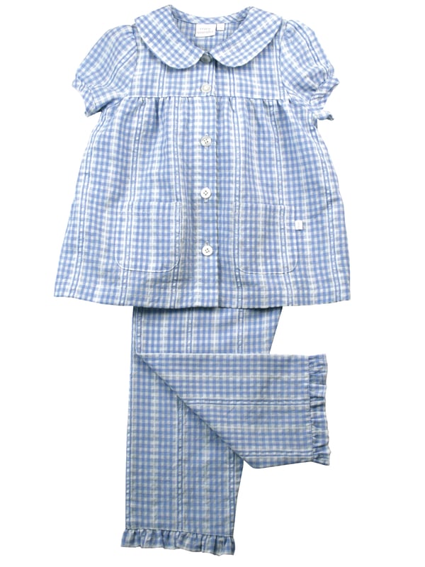 Pretty in blue... We think you're going to love our new seersucker mini check in the most beautiful pastel blue and white. There's so much woven detail in this fabric design.
Spring & Summer weight 100% Cotton with short puffed sleeves
Understated and timeless styling, our classic styling has a peter pan collar, engraved pearl effect buttons, front pockets and feminine gathers. With the trousers having an elastic waist, it makes them easy to get on and off. Our beautiful girls PJ set will keep your little one cool on the hot summer nights!
100% Cotton
Elastic waist
Front pockets
Button through top
Machine washable
Peter Pan collar