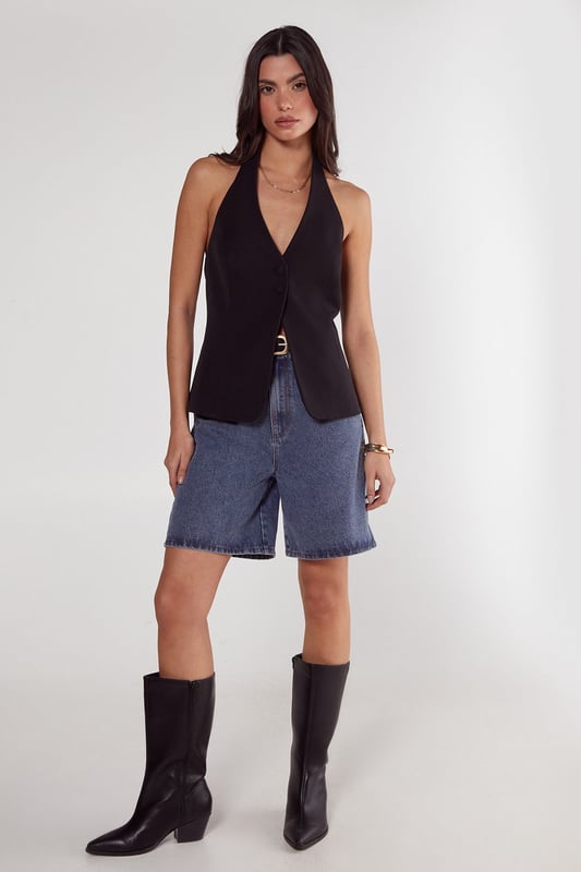 Sleek tailored vest with button front closure
        Plunging V-neckline for a sophisticated look
        Halter-style design with open back
        Single decorative button detail at the waist
        Versatile piece for layering or wearing alone
    
    Elevate your workwear wardrobe with this chic tailored vest from NastyGal's Essentials collection. Perfect for the modern professional, this sleek piece offers a contemporary twist on classic office attire. Style it over a crisp white shirt and pair with tailored trousers for a polished look that commands attention in the boardroom. For a more relaxed yet refined ensemble, layer it over a lightweight turtleneck and team with high-waisted wide-leg trousers. The vest's versatility shines through as day turns to night - simply pair it with sleek cigarette trousers and statement earrings for after-work drinks. With its ability to transition seamlessly from desk to dinner, this tailored vest is a must-have addition to any fashion-forward professional's wardrobe.