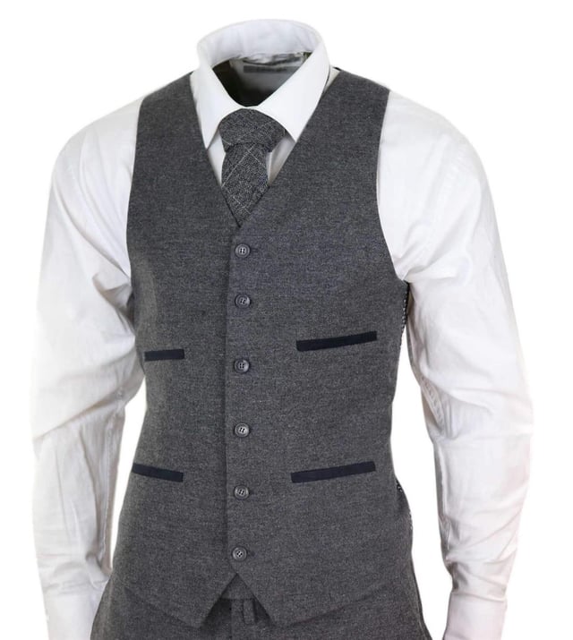 A grey suit is a key staple in every mans wardrobe and this one is no exception to this unwritten rule. Sharp, sleek and sophisticated, look the part with this premium 3 piece grey wool tweed suit, that features a slim fit cut, with a closer fit across the chest and narrower tailored trousers. the two-button jacket hangs beautifully and has a half canvas construction that moulds to your body shape the more you wear it. Contrasting velvet pocket piping, buttoned cuffs and a single back vent lend the suit a classic touch of refinement. A matching tweed waistcoat completes the 3-piece with a single breasted down style with classic tailored pockets and a back adjuster to ensure you can create your ideal fit. The suit is evergreen and contemporary at the same time and allowing you to look the best all day. Pair it with a matching waistcoat, a white shirt and shoes for a dapper finish.