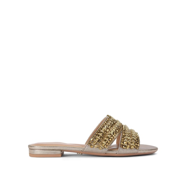This Carvela Pageant Mule sandal is crafted from a metallic gold fabric and each of the two straps are embellished with statement gold crystals.