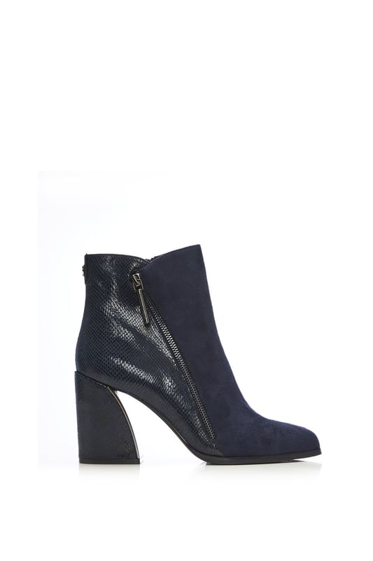 Your new favourite wide fit boot. Amy features a stunning curved block heel with a metallic inner, the contrasting textures on the shoe add further detail whilst still leaving it effortless to style. Complete with a functional inside zip and a decorative outside zip. Style with leather trousers and a blouse.