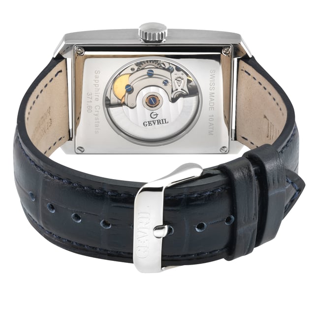 Where the triumphant achievements of human ingenuity embrace the finest offerings of the natural world, behold the Gevril Manhattanhenge Automatic Stainless-Steel Watch – an epitome of masculine sophistication. In a realm where artistry and nature's grandeur converge, this timepiece stands tall, a testament to the exquisite fusion of man's genius and the elements' magnificence.

Capturing a sublime instant when the dance of the sun intersects with the rigid grid of Manhattan's steel jungle, the Manhattanhenge watch pays homage to this biannual spectacle of unparalleled visual splendor. It is a fleeting moment frozen in time, a celebration of the majestic alignment between celestial and architectural forces.

Dominating the wrist with its commanding presence, this horological masterpiece boasts a formidable 31mm x 39mm rectangular stainless-steel case. Its contours mirror the soaring lines of skyscrapers, a symphony of masculinity and elegance that encase the heart of the watch. The centerpiece of this limited-edition marvel is the Vertical Day display, an innovation that channels the power of the sun, gracing the pristine white dial with its radiant presence. Behold through the exhibition case back the meticulous inner workings, while a secure screw-down crown stands as a sentinel of precision.

Gevril's unyielding commitment to perfection is evident in every meticulously crafted detail, including the bespoke Handmade Italian black leather strap, painstakingly fashioned by skilled artisans, securing with a confident tang buckle. This timekeeping masterpiece finds its beating heart in a Swiss-made automatic movement, an assurance that not a single sunrise or sunset shall escape your notice.

Drawn from the embrace of the natural world and elevated through the hands of true artisans, the Manhattanhenge is not just a watch – it is a harmonious sanctuary, a respite from the relentless demands of a bustling day. Amidst the chaos of life, it stands as a beacon of serenity, reminding the discerning gentleman that even in the midst of his endeavors, every pursuit deserves a momentary pause.

Gevril 371.60.62 Mens Manhattanhenge Automatic Stainless-Steel Watch
Gevril Mens Swiss Automatic from the Manhattanhenge Collection
31mm x 39mm Rectangle 316L Stainless Steel Case, White Dial with Exhibition Case Back
Day date
Push Pull
Limited Edition
Genuine Handmade Italian Blue Leather Strap with Tang Buckle
Anti-reflective Sapphire Crystal
Water Resistant to 100 Meters/10ATM
Swiss Made Automatic, Day Date, ETA 2636-2