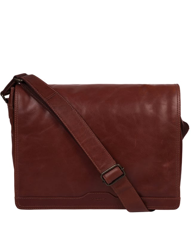 Handcrafted from full-grain natural leather, the 'Zico' messenger bag from Conkca London comes with a robust finish. The handsome accessory features a fold-over top secures a spacious central compartment which is lined with natural, untreated 100% cotton lining alongside rustic metal fittings and zips. Ample storage space is provided by a padded laptop pocket on the interior. Comes with an adjustable strap with a maximum drop length of 70cm and adorned with the handsome Conkca leather label.