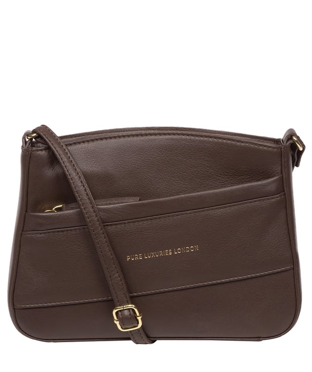 The 'Helena' cross body bag from the Pure Luxuries Marylebone collection is handcrafted from high-quality, genuine Nappa leather with a natural super-soft touch. The zip-over top opens to reveal a 100% cotton-lined interior. The spacious compartment features two slip pockets to help maintain an organised bag. A zipped pocket on the front of the bag provides on-the-go storage. Features gold-coloured metal fittings and zips alongside the adjustable slim leather strap, with a maximum drop length of 65cm. The Pure Luxuries logo is embossed in gold foil for a beautifully simple finishing touch.