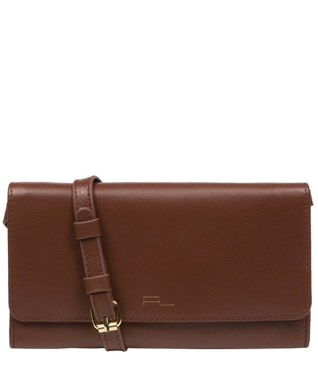 The 'Saffron' cross body clutch bag from the Pure Luxuries Marylebone collection is handcrafted from high-quality, genuine Nappa leather with a natural super-soft touch. The minimalistic fold-over top is secured by a gold-coloured magnetic press stud. The interior is lined with 100% cotton and features slip pockets and card slots to help keep an organised bag. Comes with an adjustable slim leather strap with a maximum drop length of 65cm. The strap is also removable by releasing the two interior press studs, transforming the bag into a clutch bag. Furnished with gold-coloured metal fittings. The minimalist Pure Luxuries logo is embossed in gold foil for a beautifully simple finishing touch.