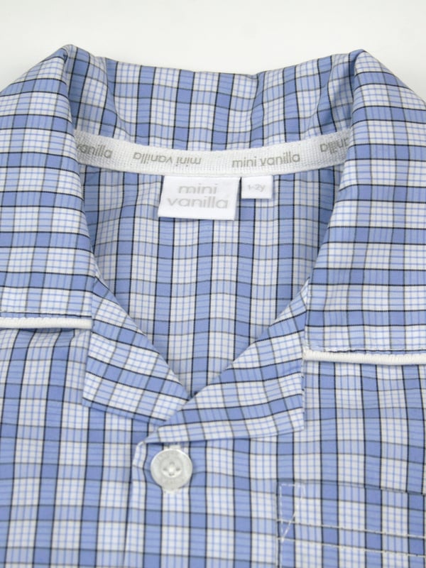 Boys mini check PJ set in shades of mid blue. Spring & Summer weight 100% Cotton with short sleeves
Classic traditional styling, engraved pearl effect buttons and contrast piping. With an elastic waist, making them easy to get on and off 
100% Cotton
Elastic waist
Front pocket
Button through top
Machine washable
Contrast piping detail