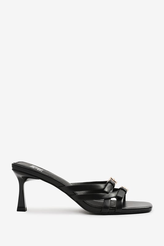 Step up your style with these Torigh Cross Over Buckle Details Strap Heel. Perfect for casual outings or dressy events, these sandals combine modern elegance with lasting comfort, making them a must-have addition to your wardrobe.

Key Features: 
Durable Construction: Crafted with high-quality faux leather, these sandals are designed to last. The sturdy heel and durable straps provide reliable support, ensuring they can withstand regular wear without compromising style.
Chic Design: The multi-strap design with subtle metallic accents exudes elegance and sophistication. The square toe and slender heel add a modern, fashion-forward touch that enhances their timeless appeal.
Comfortable Fit: Featuring a padded insole and a balanced heel height, these sandals provide all-day comfort without sacrificing style. The open design ensures breathability and ease of wear, making them perfect for any occasion.

Specifications:
o   Material: High-quality faux leather
o   Heel Type: Slender heel
o   Closure: Slip-on design for convenience

Elevate your footwear collection with these Torigh Cross Over Buckle Details Strap Heel. Combining chic design, durable construction, and superior comfort, they are perfect for making a statement wherever you go!