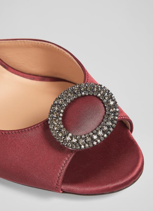 LK Bennett Belle Formal Sandals, Burgundy An elegant and timeless take on a party sandal, our Belle sandals have a glamorous, vintage feel. Crafted from lustrous burgundy satin, they're a peeptoe style with a sparkling, oval-shaped crystal buckle embellishment, a delicate ankle strap and a shapely stiletto heel. Wear them with your favourite party dresses or to instantly dress up a pair of tailored trousers.
