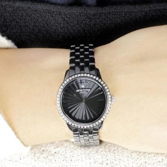 Japanese Made Quartz Automatic Movement. 36mm x 11mm Black Polished Ceramic Case. Solid Stainless Steel Caseback. Bezel Set with Gems. Push-Pull Crown. Black Sunray Dial. Polished Stainless Steel Hands and Indexes. 15mm Width Black Ceramic Bracelet with Hidden Deployment Clasp. Water Resistant to 30 Meters 3ATM. This watch is and comes with the Box and Paperwork.