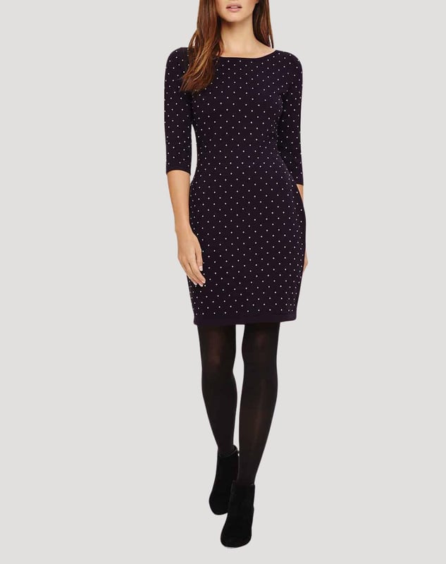A fitted knit dress that falls above the knee, designed with a scoop neckline and 3/4 length sleeves. This style has stud detailing and can be worn with or without tights.
Fit: Stretch Fit, Sizing: As expected