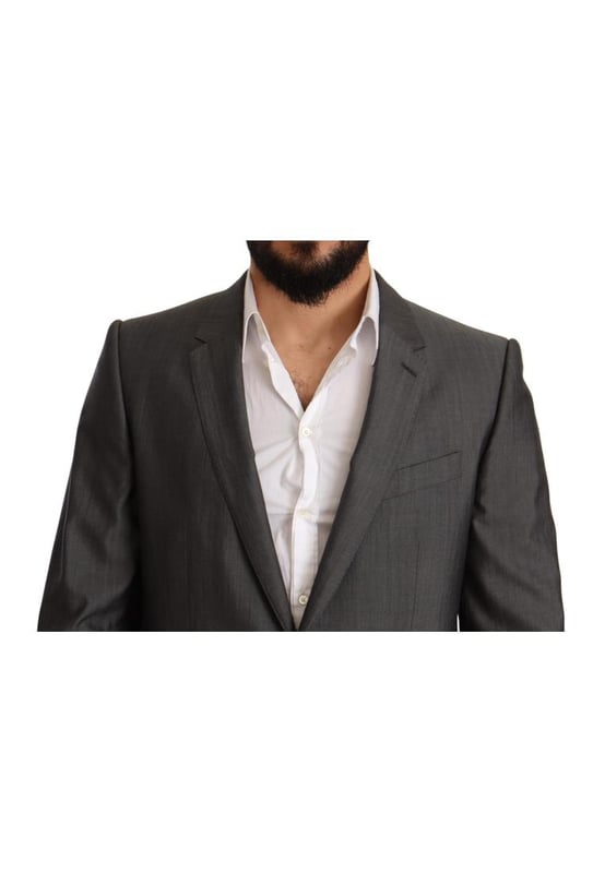 100% Authentic Dolce & Gabbana Suit
  Model: MARTINI
  Style: Single breasted 2 piece suit; includes blazer and pants
  Color: Gray metallic
  Closure: Two button closure
  Fitting: Slim fit
  Two inside pockets
  One open vent in the back
  3-way pants zipper closure
  Logo details
  Made in Italy
  Material: 65% Wool 35% Silk
  Lining: 100% Rayon