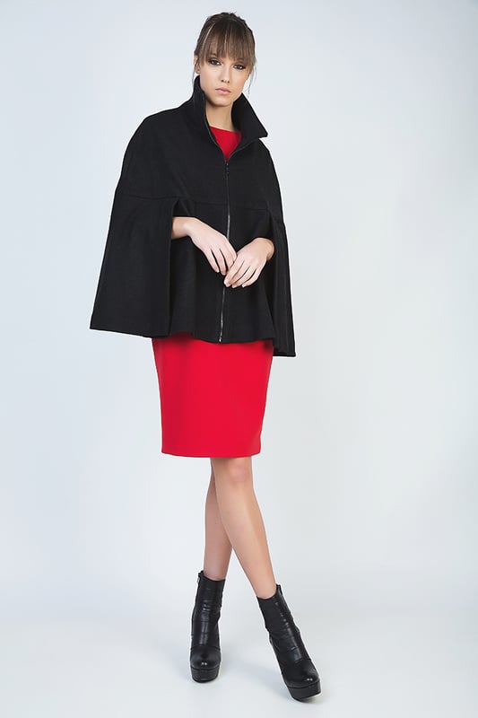 Winter cape in black woven fabric. Fastens in the front with a decorative black plastic zip. Upright colour. Openings for the arms under the bust. Loose fit. Fully lined in black woven fabric. Our model has height 178 cm and wearing size 36. Measurements for size 38 (in cm):Bust-66; Body length-68; Waist-86; Hemline-96. Garment is loose fitted.
