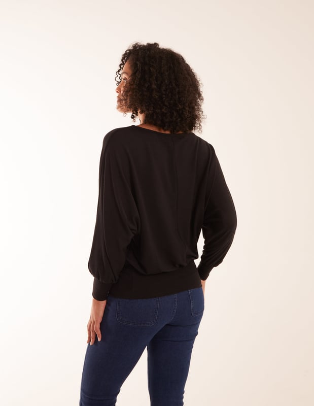 Doesn't matter if you are going to work or a late-night cocktail with friends, you will not go wrong with the batwing top. You can match this top with wide leg jeans and short heel boots.