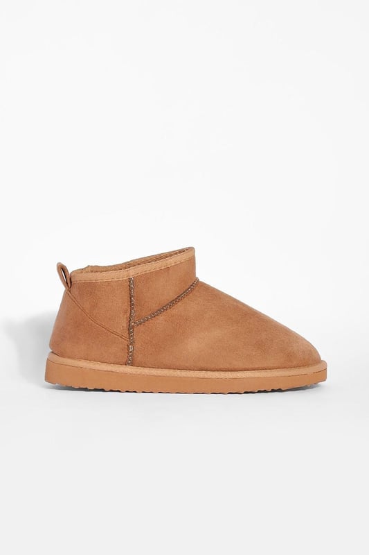 Ultra mini design for a contemporary twist on classic boot styles
        Flat heel between 0 and 2cm for all-day comfort
        Synthetic suede upper for a soft, luxurious feel
        Slip-on style for effortless wear
        Versatile silhouette suitable for various casual occasions
    
    Step into style with these ultra mini shoe boots, a must-have addition to your casual footwear collection. The sleek, low-profile design offers a modern take on traditional boot styles, perfect for the fashion-forward individual. Pair them with cropped jeans and an oversized jumper for a relaxed weekend look, or team with a flowy midi dress for a chic daytime ensemble. The flat heel ensures comfort for extended wear, making these boots ideal for family gatherings, shopping trips, or casual outings with friends. Their versatility allows for seamless transition from day to night, offering endless styling possibilities for the contemporary British fashionista. Embrace the latest trends while prioritising comfort with these ultra mini shoe boots, a true embodiment of Boohoo's commitment to accessible, on-trend fashion.