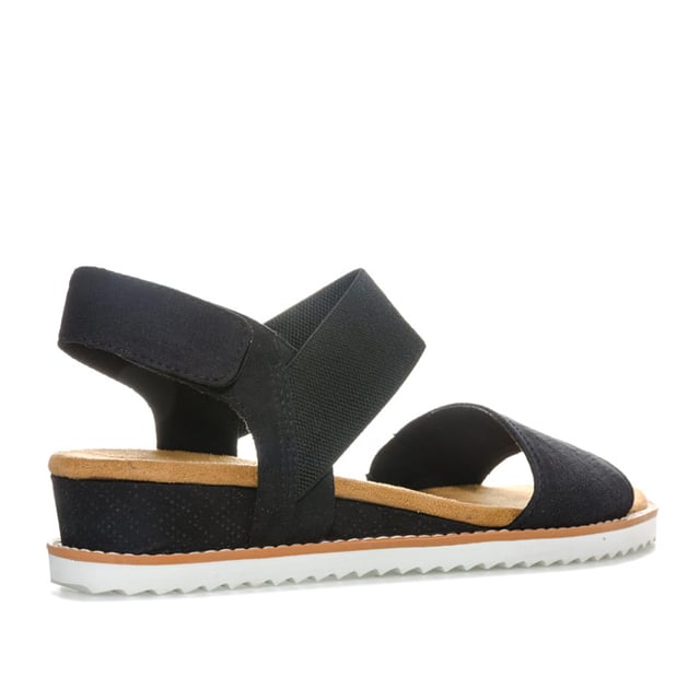 Women's Skechers BOBS Desert Kiss Sandals in Black Womens Skechers BOBS Desert Kiss Sandals in black. Strappy casual comfort sandals.- Soft and smooth durasuede fabric upper.- Bandage strap to front with perforated detail.- Elasticated instep ankle strap for flexible comfort.- Slingback ankle strap with hook and loop fastening for a custom fit. - Smooth fabric strap lining. - Memory Foam cushioned comfort insole.- Durasuede wrapped low wedge midsole with perforated detail. - Flexible traction outsole. - Wedge height: 3cm (1.25“) approximately.- Textile upper and lining Synthetic sole. - Ref: 31440-BLKMeasurements are intended for guidance only.