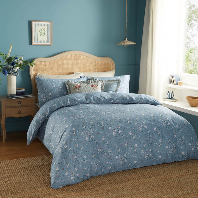 Transform your bedroom into a serene retreat with the Bronte Floral Duvet Cover Set. Crafted from 100% cotton and featuring a 144-thread count, this duvet cover combines comfort with timeless elegance. The classic English garden ditsy print showcases delicate lilac forget-me-nots and subtle foliage, offering a refined touch that speaks to lovers of nature and understated beauty. The same exquisite design graces both sides, allowing it to stand alone as a statement piece. With Bronte, experience the perfect blend of sophistication and natural allure that invites tranquillity and style into your living space. 200 x 200cm