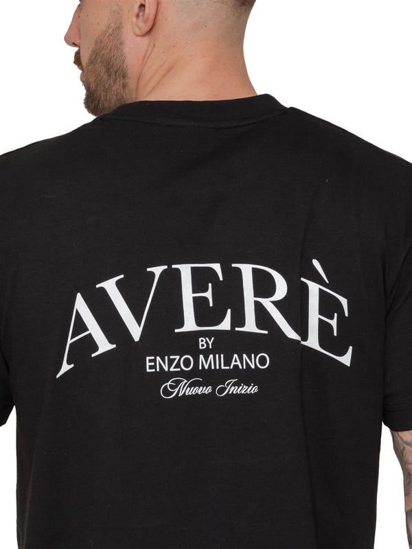 Introducing the Averè by Enzo Milano Oversized T-shirt. Crafted for both style and comfort, this T-shirt features a relaxed fit, ideal for everyday wear. The front displays a subtle Averè logo on the chest, while the back boasts a bold, large-scale Averè branding with "Enzo Milano" text, giving it a contemporary and trendy vibe. Made from soft, breathable fabric, this loose fit, crew neck t-shirt is perfect for pairing with jeans or shorts, offering an effortlessly casual yet stylish look. Ideal for those seeking comfort with a fashionable edge
